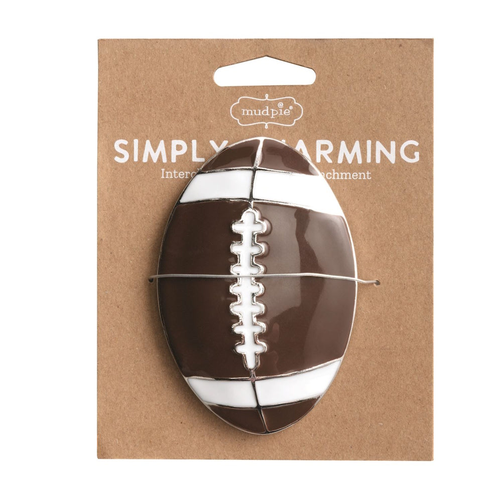 Mud Pie Simply Charming brown and white ceramic football magnetic charm on a brown cardboard package.