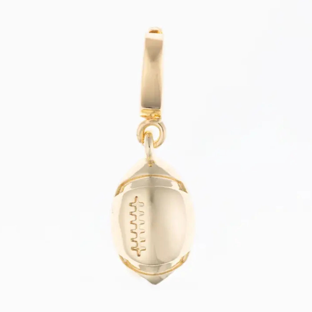 Polished gold football pendant charm with engraved laces detail on a white background.