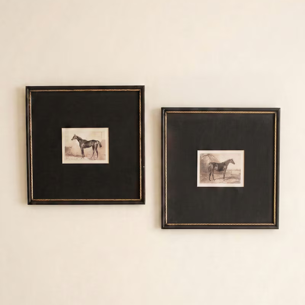 Pair of vintage equestrian horse prints in dark square frames with gold inner trim on a off-white wall.