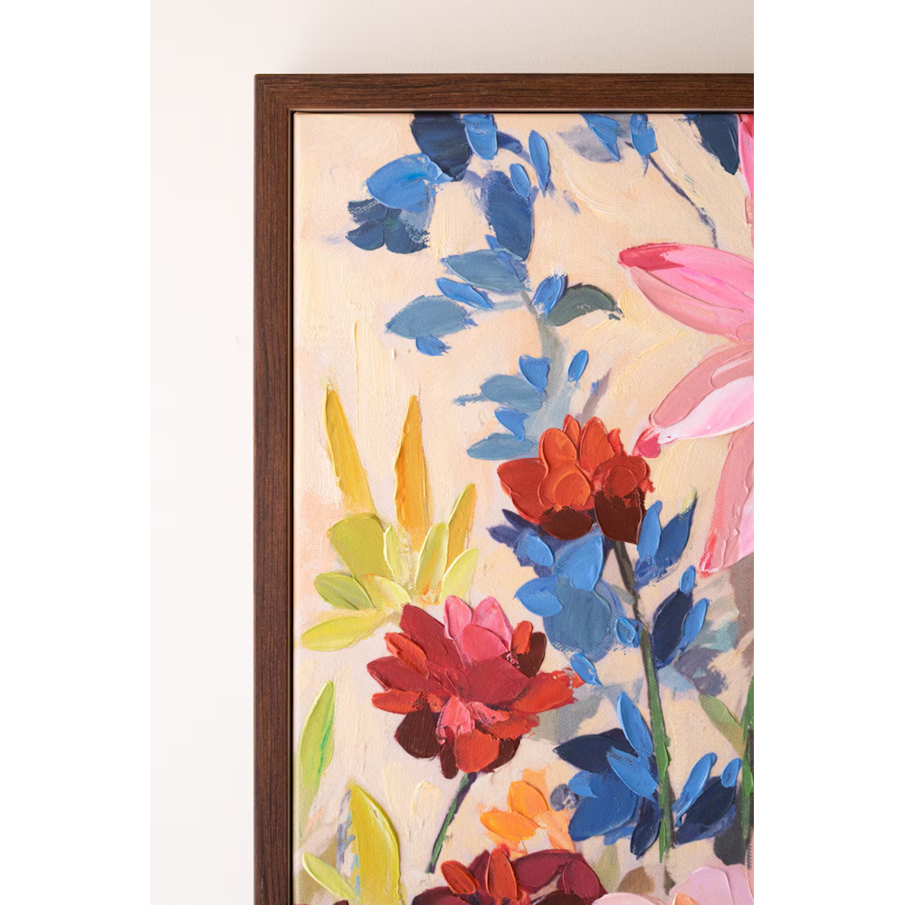 Detail shot of impasto paint texture on a framed colorful wildflower floral canvas painting.
