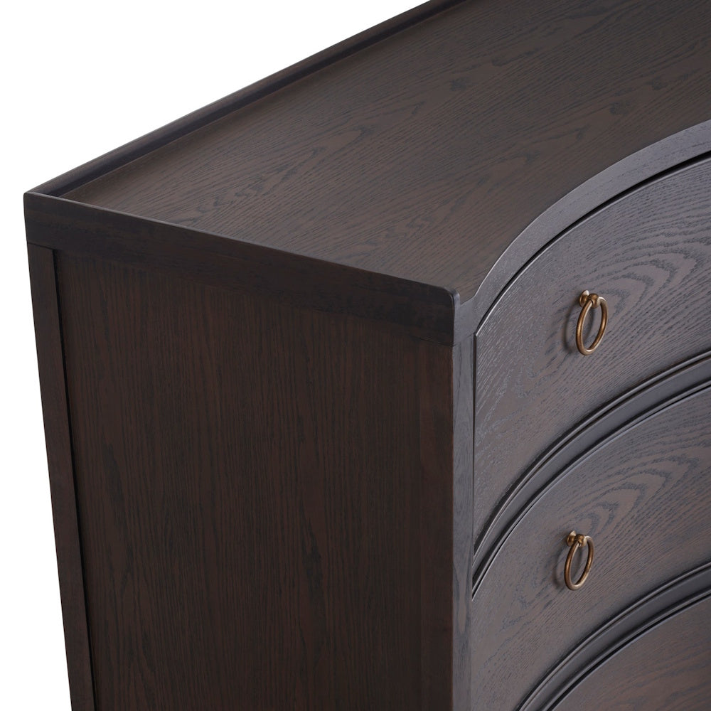 Dark wood curved dresser with brass ring pulls and visible wood grain texture.
