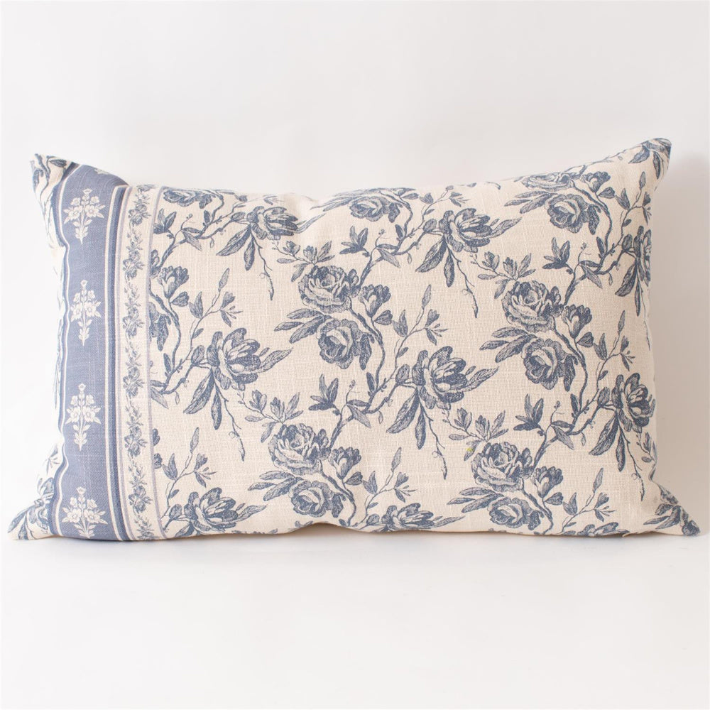 French blue floral lumbar pillow with vintage rose pattern and decorative border on cream linen fabric.