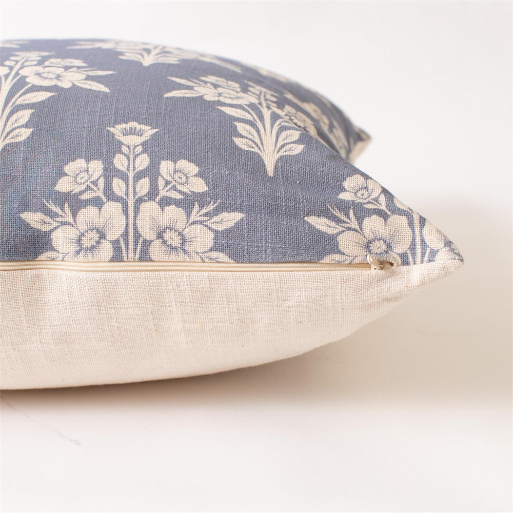 Close-up of a French blue floral medallion square pillow with cream linen backing and hidden zipper closure.