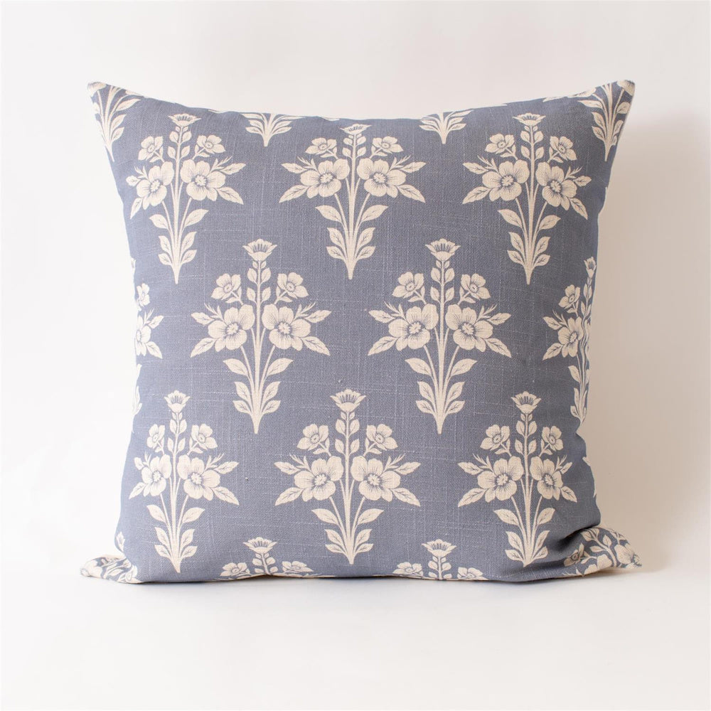 French blue square throw pillow featuring a white floral medallion pattern on a textured linen fabric.