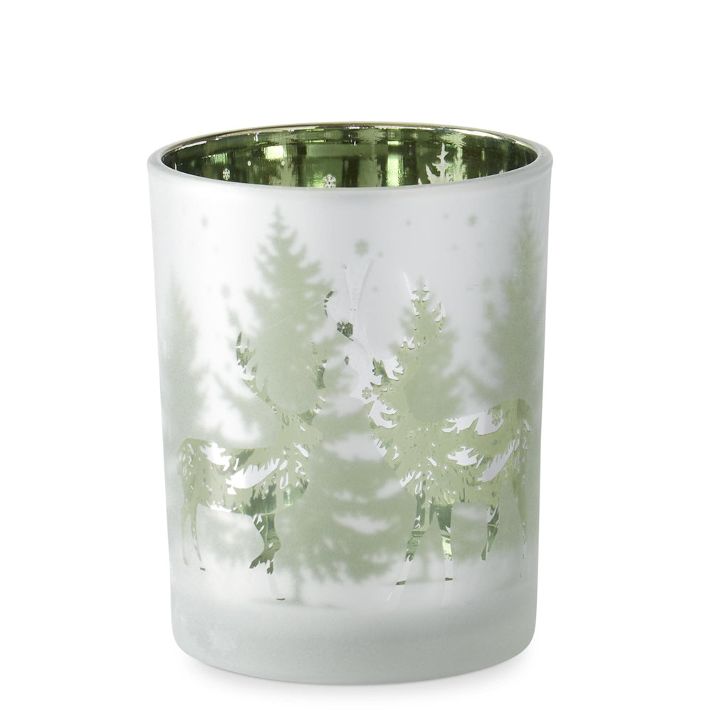 Large frosted glass candle holder with green metallic interior, featuring deer and pine trees in a winter scene.