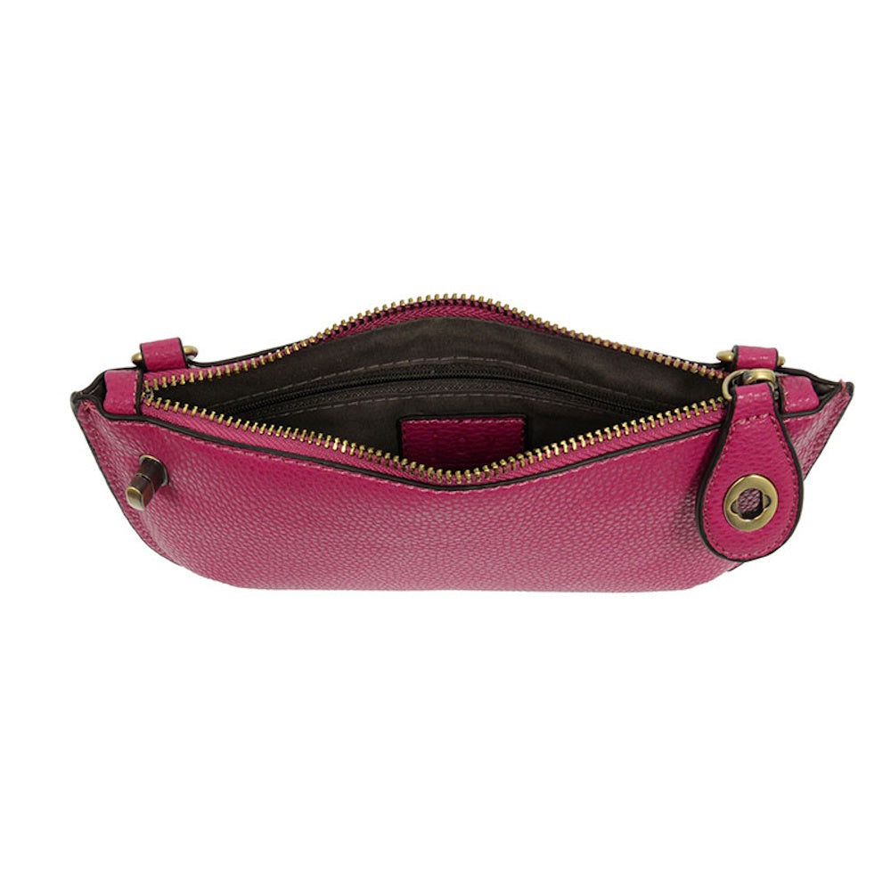 Open fuchsia pebbled leather mini crossbody bag with gold zipper and brown interior lining on a white background.