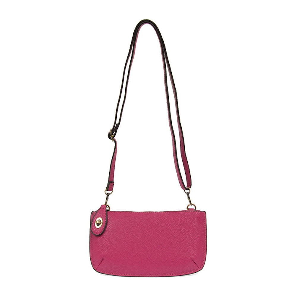 Fuchsia pink pebbled faux leather mini crossbody bag with adjustable strap and gold hardware accents.