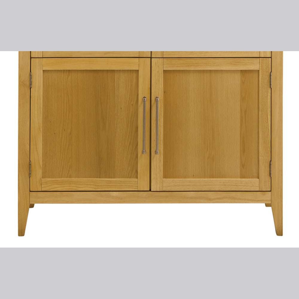Close-up of light oak wood cabinet doors with silver metal handles and visible wood grain texture.