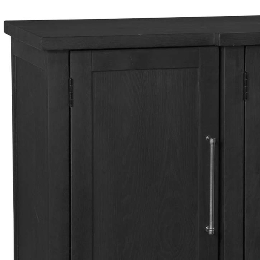 Close-up of a black wooden cabinet door with a sleek silver metal handle.