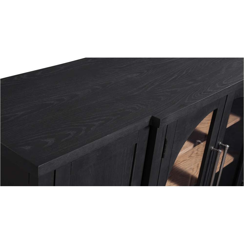 Close-up of a black wood sideboard featuring visible grain, glass-front doors, and silver metal handles.