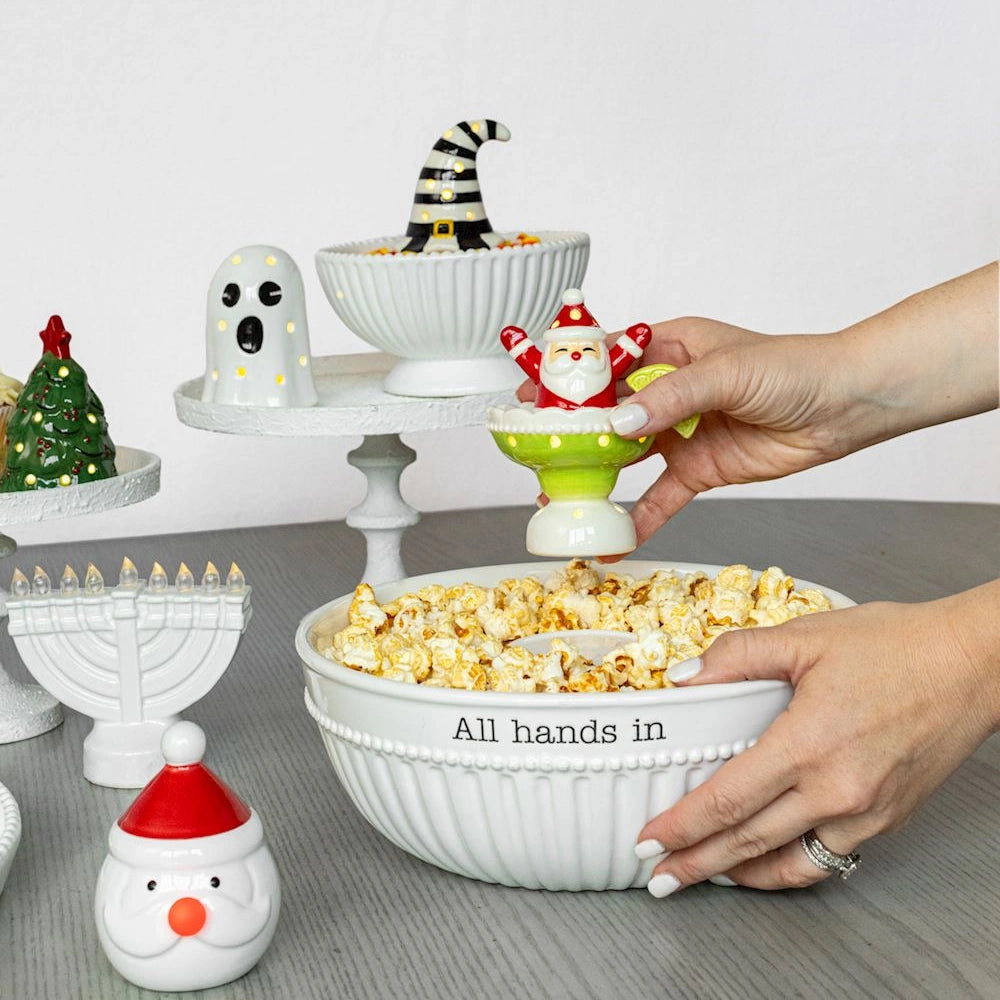 Ceramic holiday serving bowls and light-up sitters for Halloween, Christmas, and Hanukkah table decor.