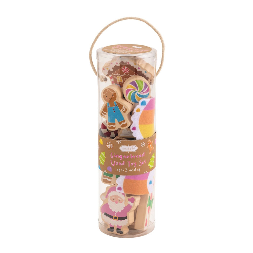 Wooden gingerbread-themed Christmas toy set packaged in a clear cylinder with a rope handle.