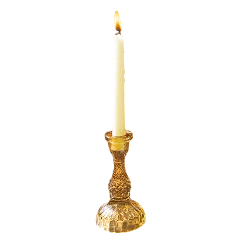 Amber vintage-style textured glass taper candle holder with a lit white candle on a white background.