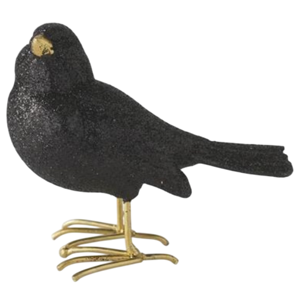 Glittery black resin bird figurine with gold beak and feet for spooky Halloween decor.