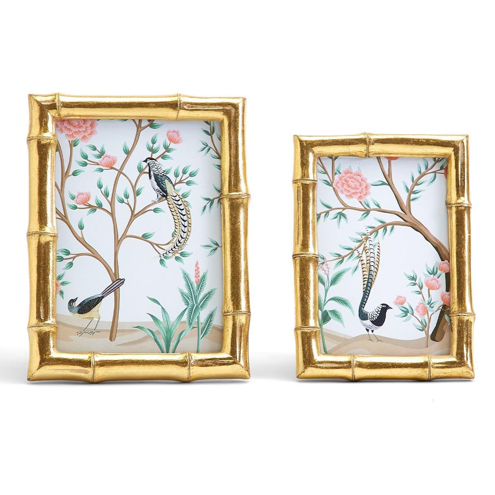 Front view of two gold faux bamboo photo frames displaying botanical bird artwork.