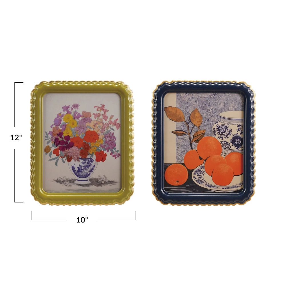 Two scalloped photo frames in gold and navy blue featuring floral and orange still life art prints, 10x12 inches.