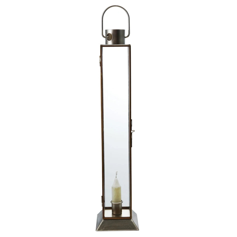 Tall gold metal and glass lantern taper candle holder with a slender rectangular frame and a round top handle.