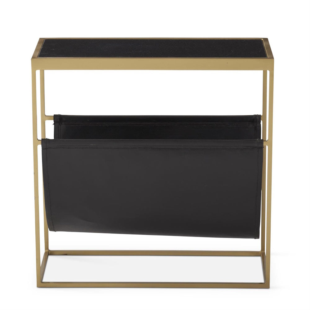 Front view of a gold metal side table with a black top and an integrated black magazine sling.