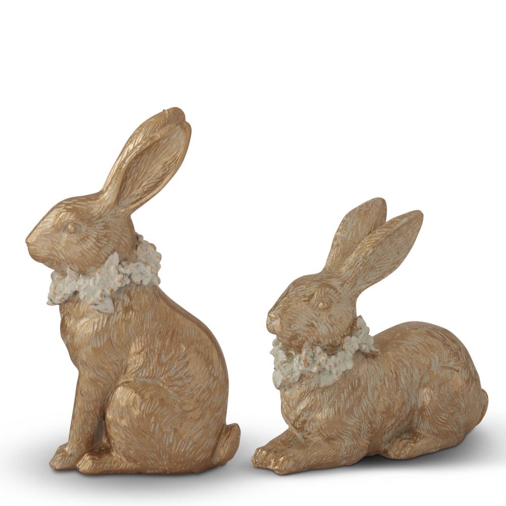 Gold resin Easter bunny figurines with floral collars, set of two decorative rabbits on white background.