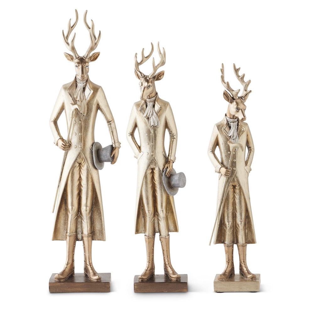 Three gold resin standing deer figurines dressed in vintage coats with walking sticks and top hats.