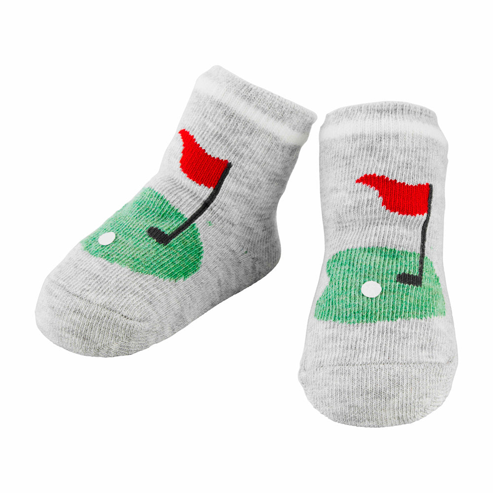 Grey baby socks with a golf theme featuring a green putting hole, red flag, and white golf ball.