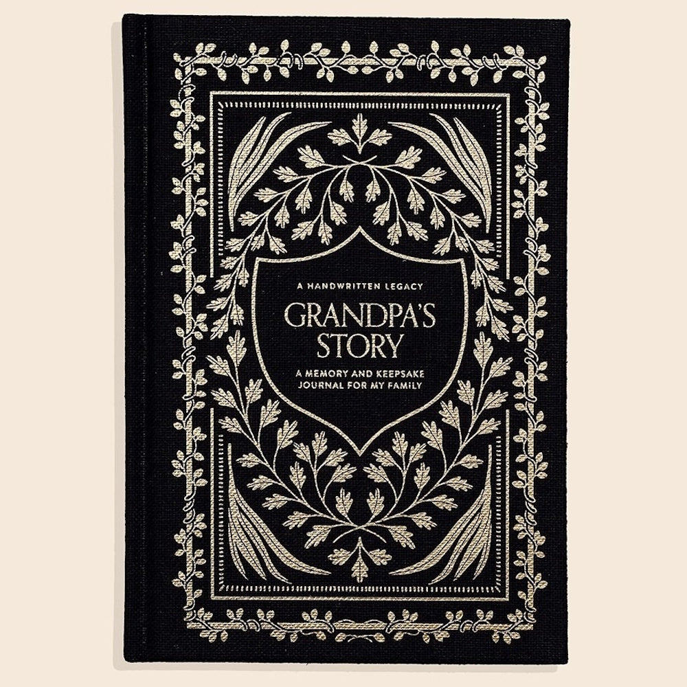 Black "Grandpa's Story" memory journal with gold leaf borders and elegant floral illustrations for a family keepsake.