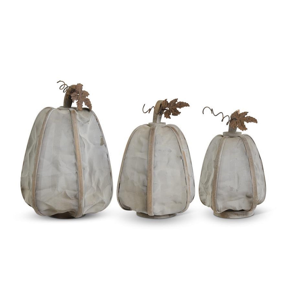 Three gray mesh pumpkins with wood ribs, rusty metal stems, leaves, and curly vines on a white background.