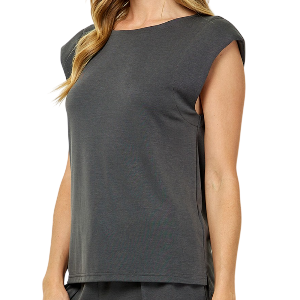 Woman wearing a gray, sleeveless padded-shoulder top against a white background.