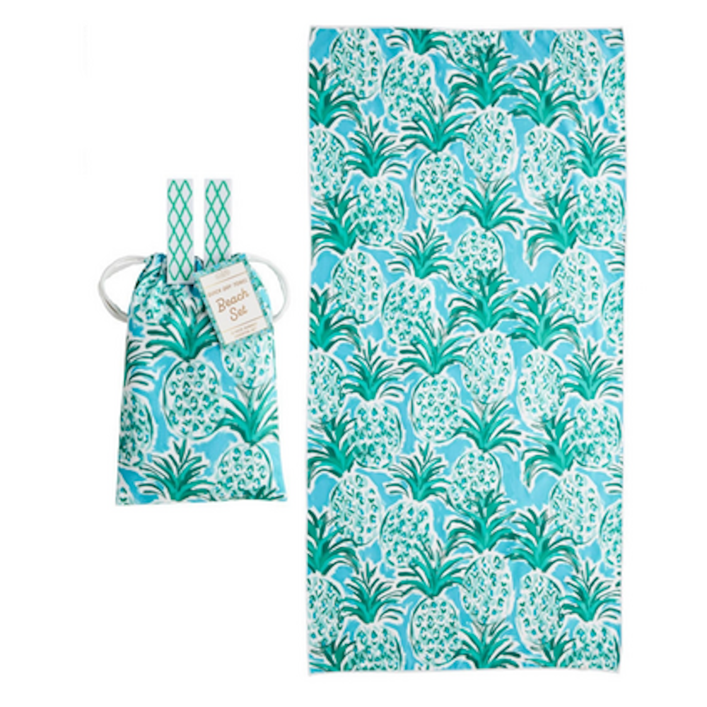 Blue and green pineapple pattern beach towel next to its matching drawstring carrying pouch.