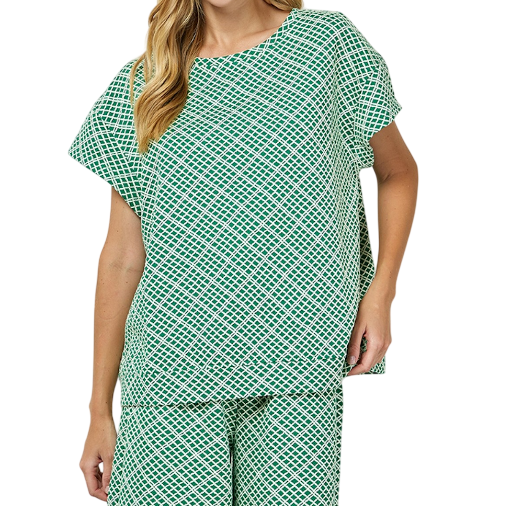 Woman wearing a green and white geometric grid pattern short-sleeve top and matching pants set.