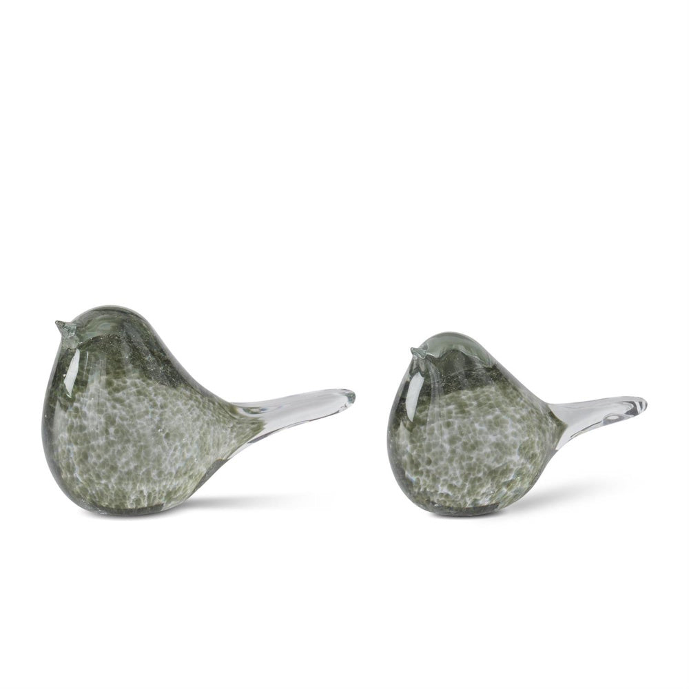 Two glass bird figurines with green speckled patterns and clear tails on a white background.