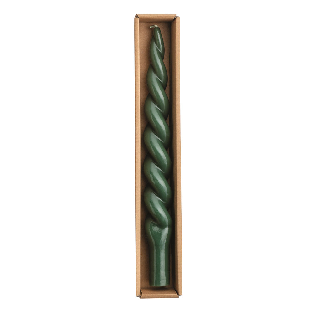 Dark green spiral wax taper candle in a cardboard box, viewed from above.