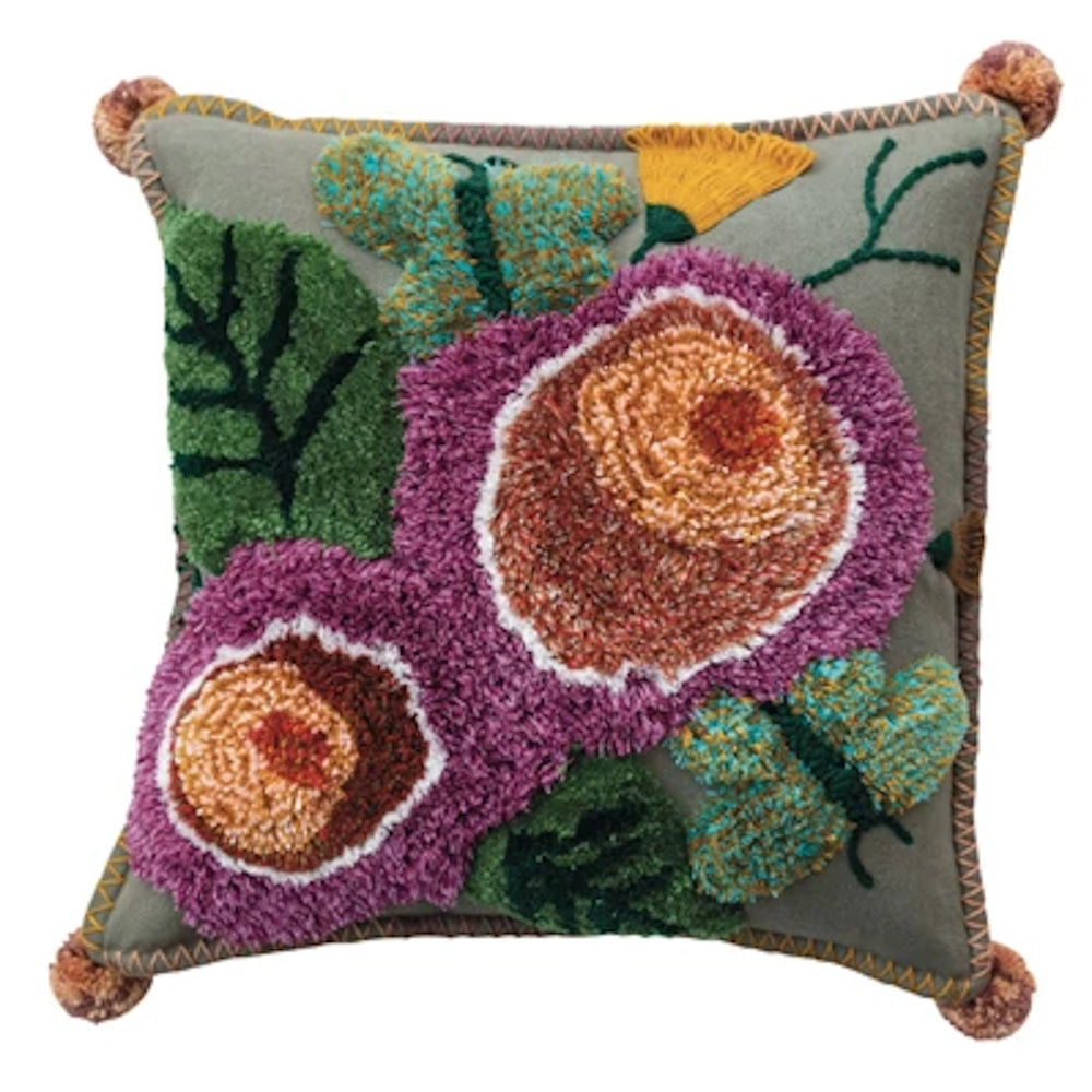 Hand-tufted floral throw pillow with purple 3D flowers, green leaves, and butterfly embroidery on sage green fabric.