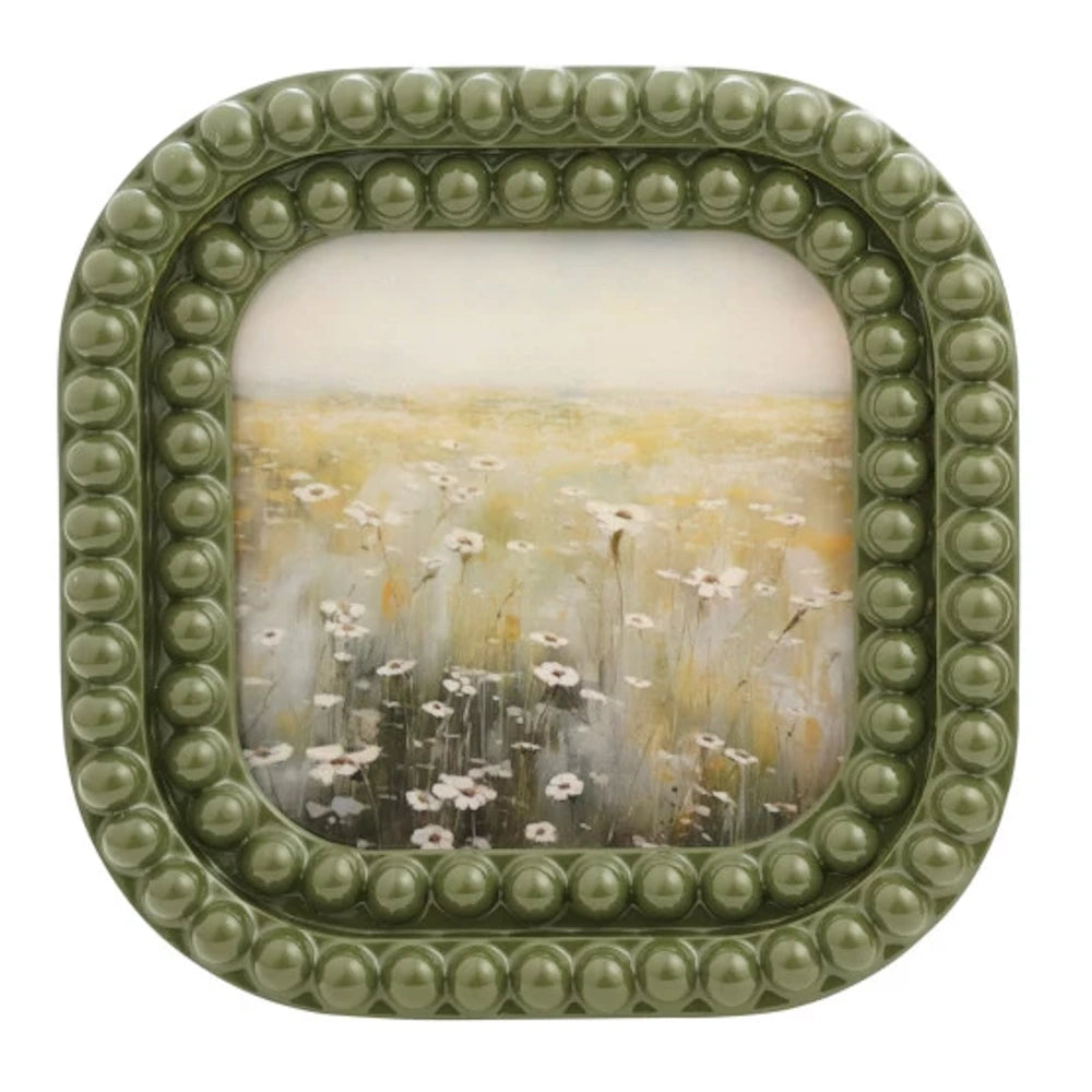 Sage green square resin bobbin frame featuring a floral wildflower meadow painting with white daisies.