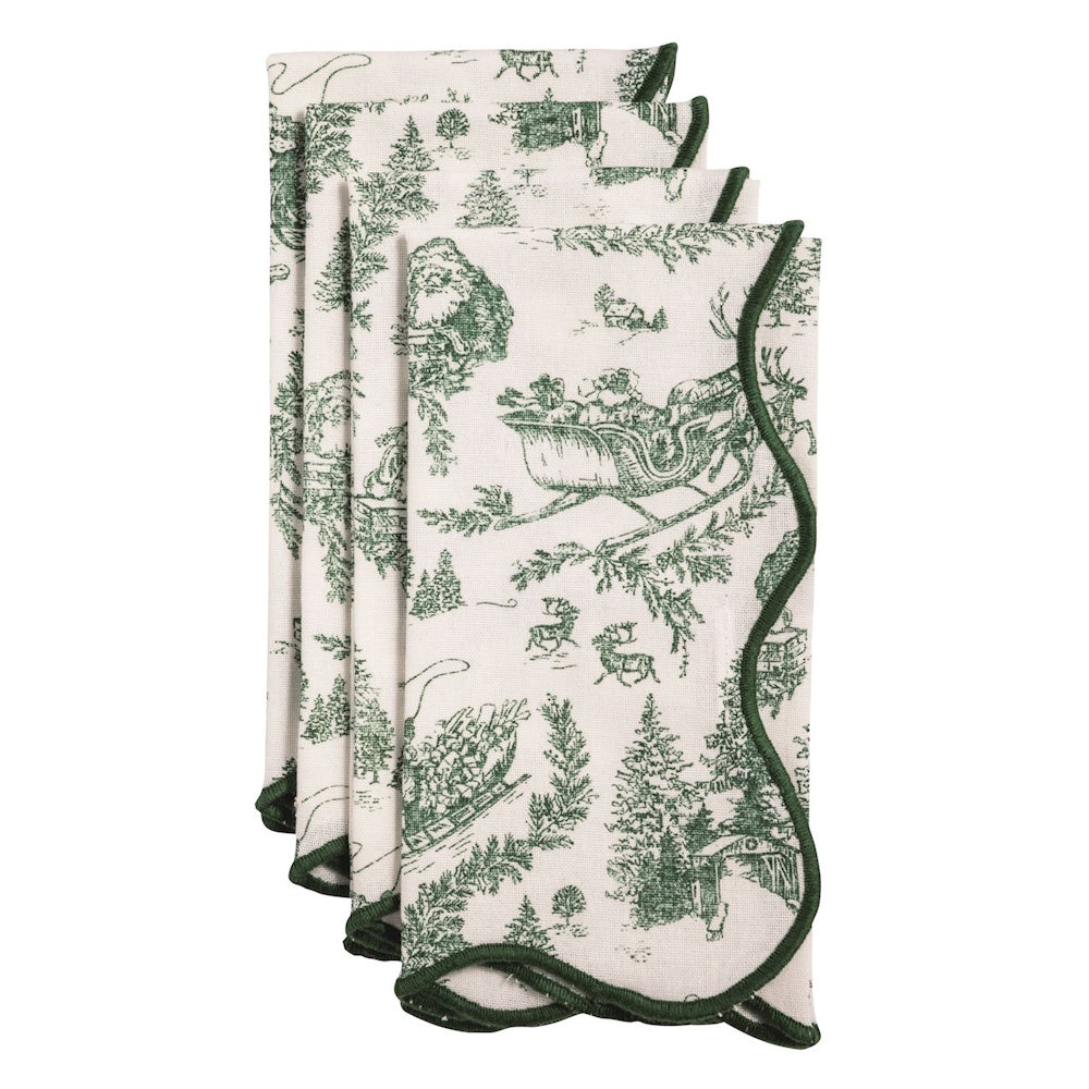 Set of white dinner napkins with green toile holiday print and green scalloped border.