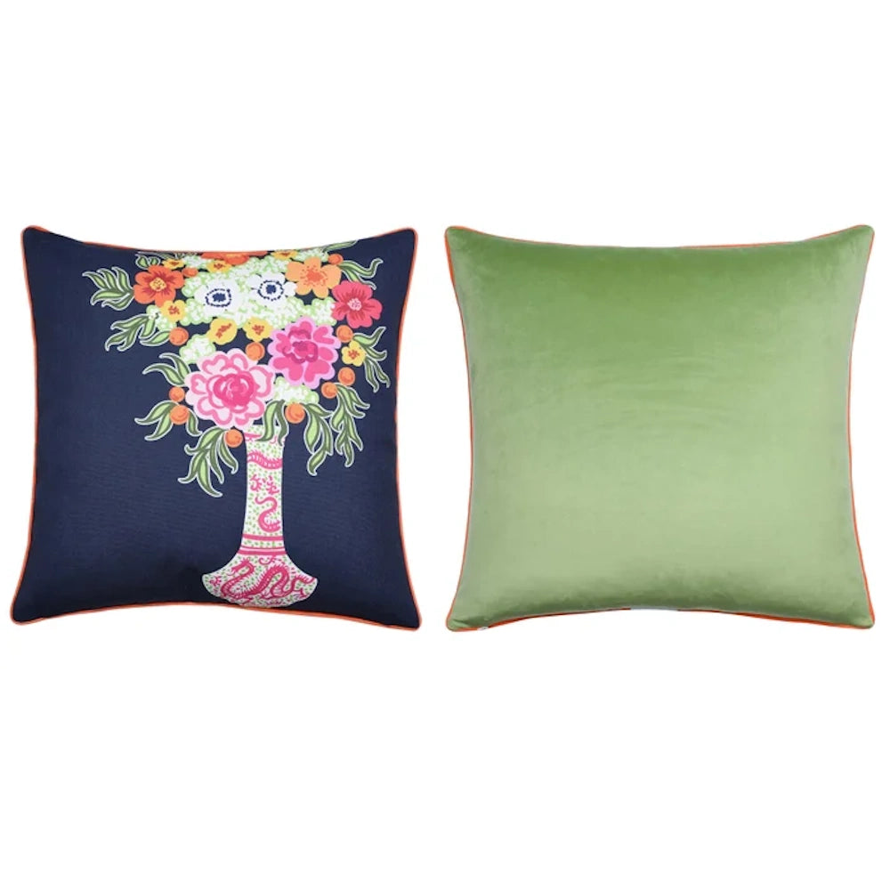 Navy blue floral vase throw pillow and solid sage green velvet cushion with orange piping.