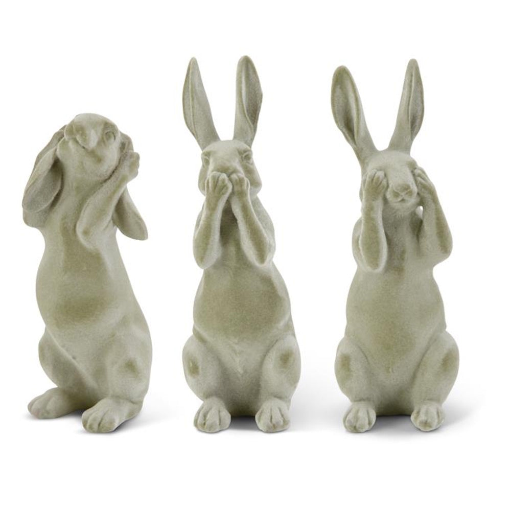 Green velvet hear no see no speak no evil rabbit figurines set against a white background.