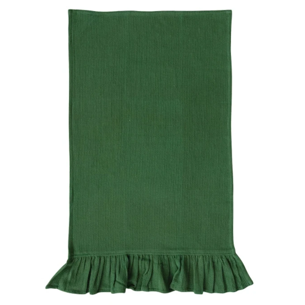 Flat-lay view of a dark green waffle-weave kitchen towel featuring a ruffled bottom trim.