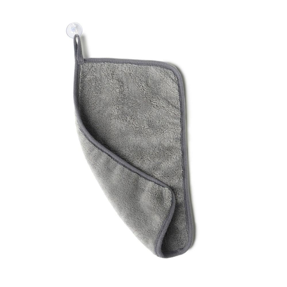 Grey microfiber makeup remover towel with a suction cup hanging loop, shown on a plain white background.