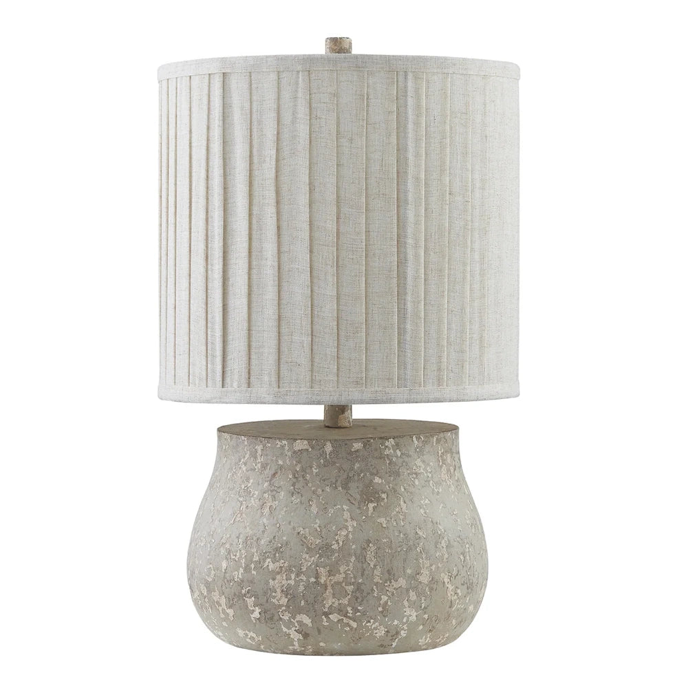 Rustic concrete table lamp with a distressed gray base and a pleated linen drum shade for farmhouse decor.
