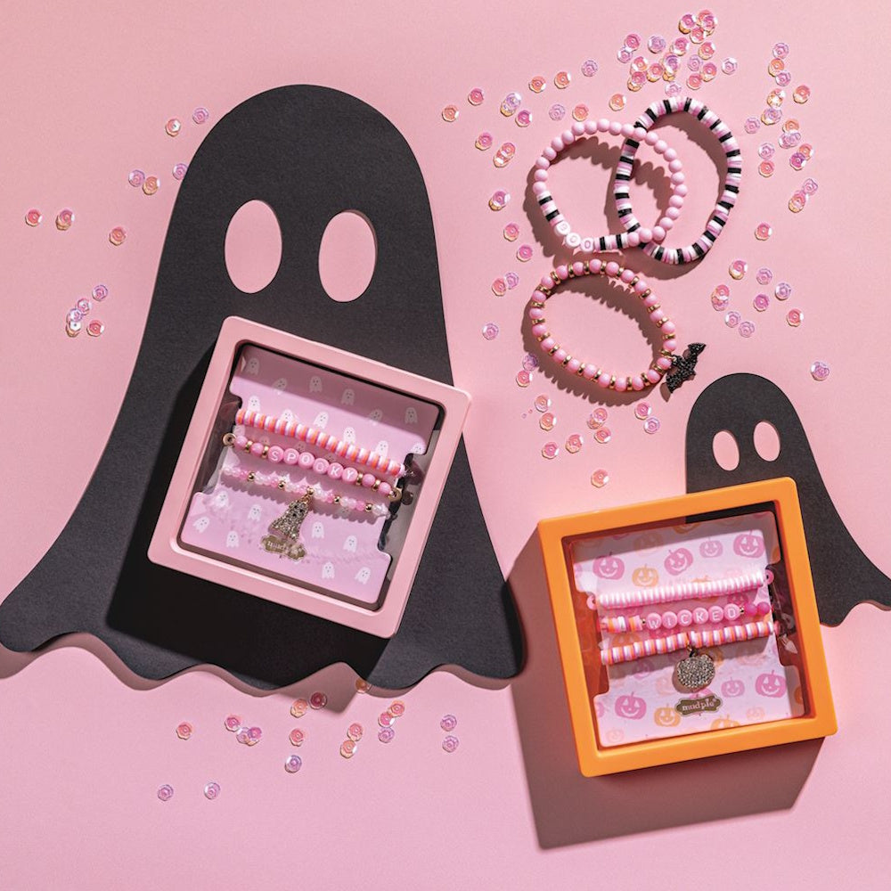 Pink Halloween beaded bracelet sets with ghost and bat charms on a pink background.