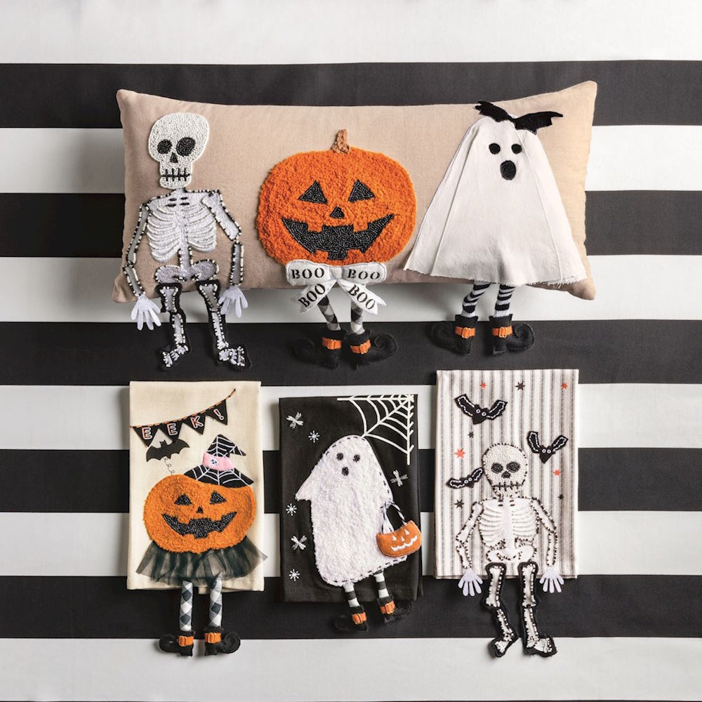 Halloween dangle leg pillow set against a black-and-white striped background alongside three decorative Halloween hand towels.