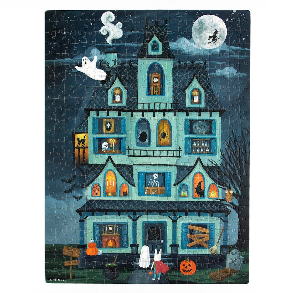 A Halloween jigsaw puzzle of a spooky blue haunted mansion with ghosts, skeletons, and a full moon.