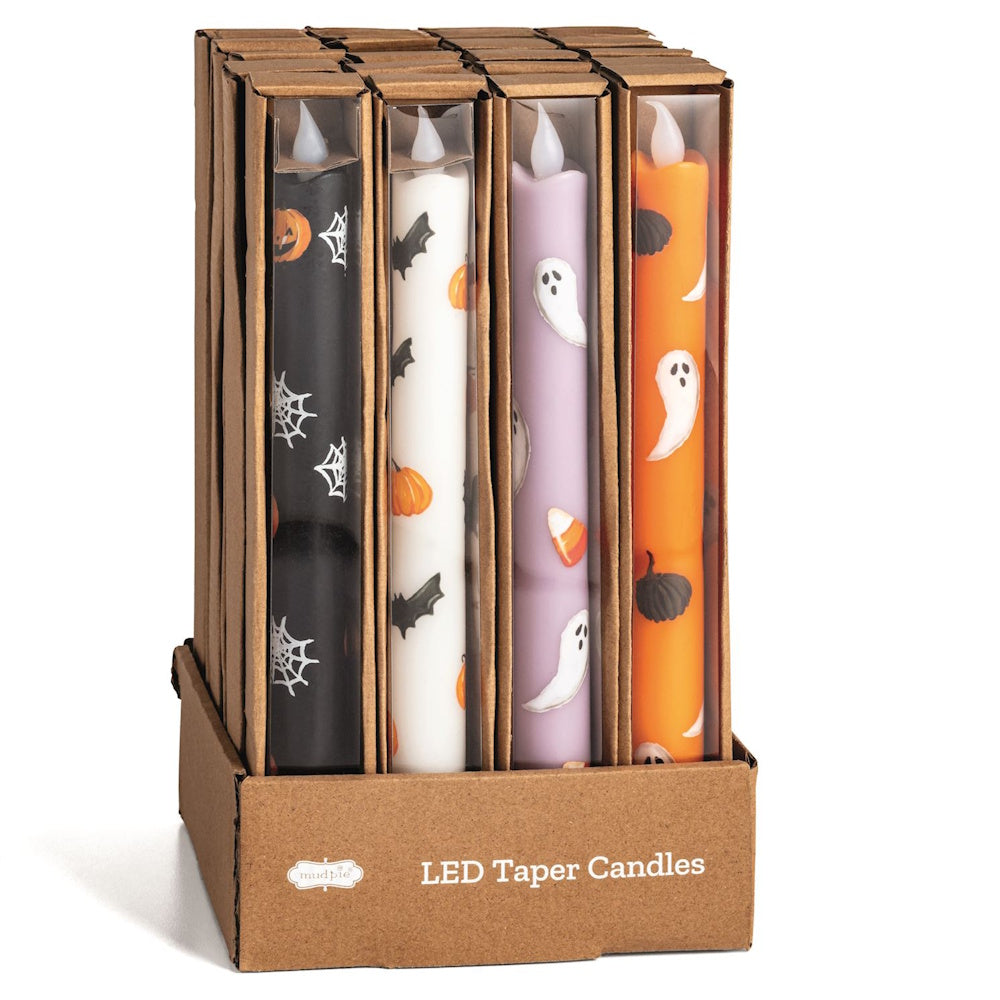 Mud Pie Halloween LED taper candles in cardboard packaging featuring spiders, bats, ghosts, and pumpkins.
