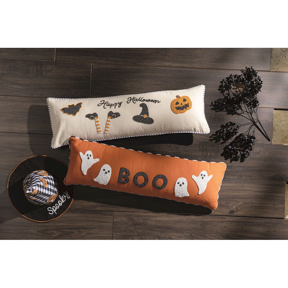 Long Halloween lumbar pillows with beaded ghost and pumpkin designs on a dark wood floor.