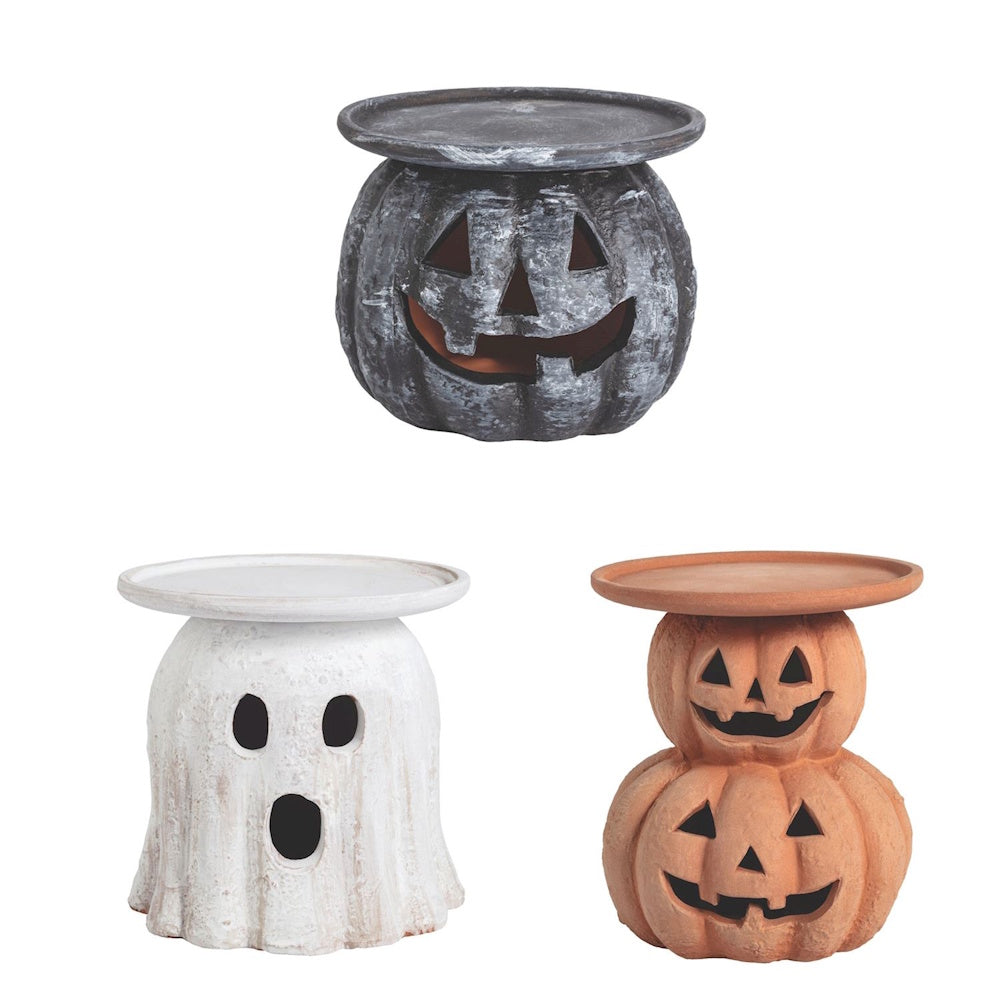Halloween pillar candle holders shaped like a ghost, jack-o'-lantern, and stacked pumpkins.