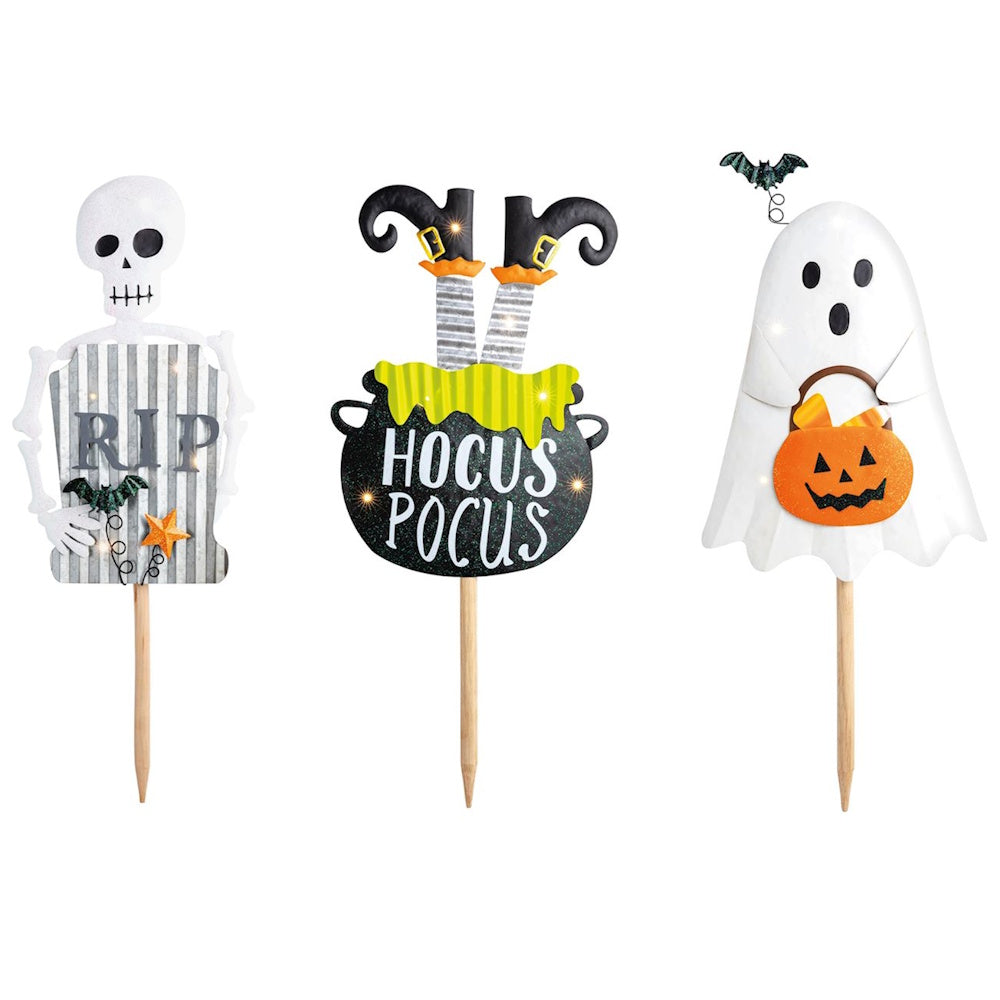 Set of 3 Halloween yard stakes featuring a skeleton RIP sign, witch cauldron, and ghost holding a pumpkin.