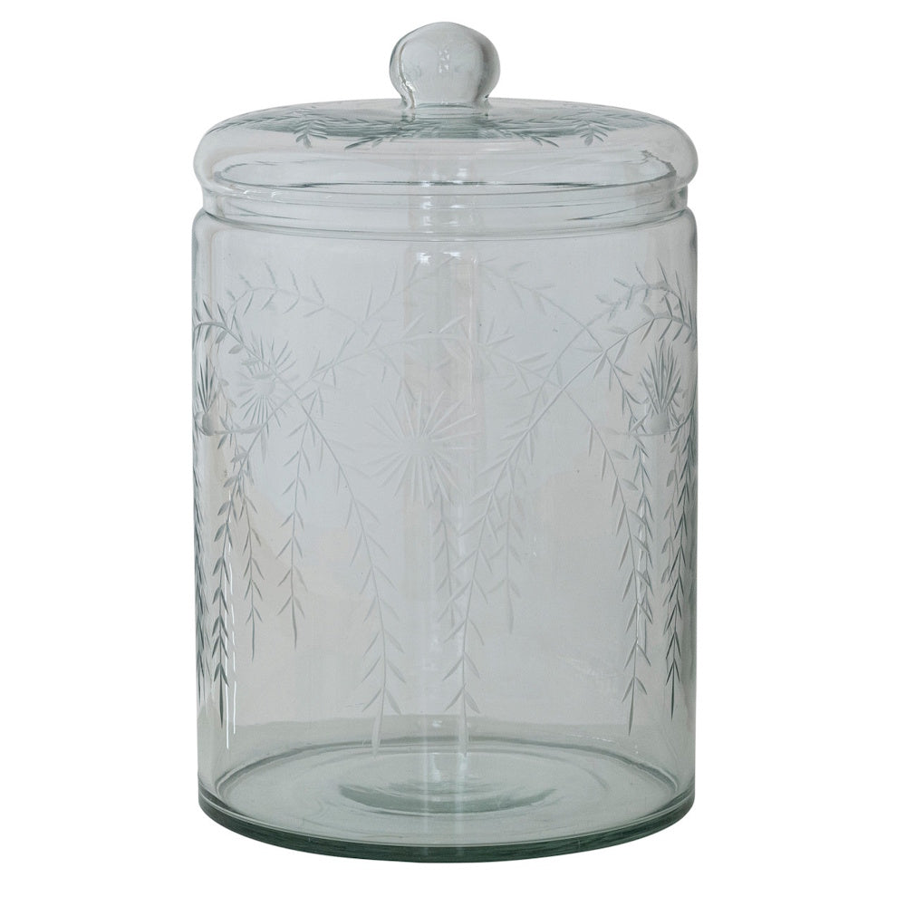 Clear hand-blown glass storage jar with a matching lid and etched botanical leaf patterns.