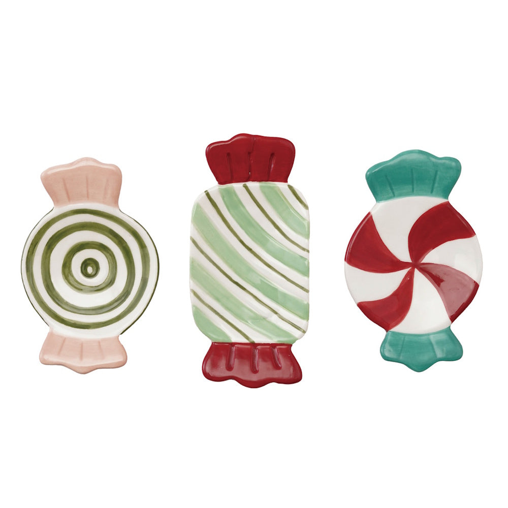 Three ceramic candy-shaped dishes with colorful hand-painted festive patterns on a white background.