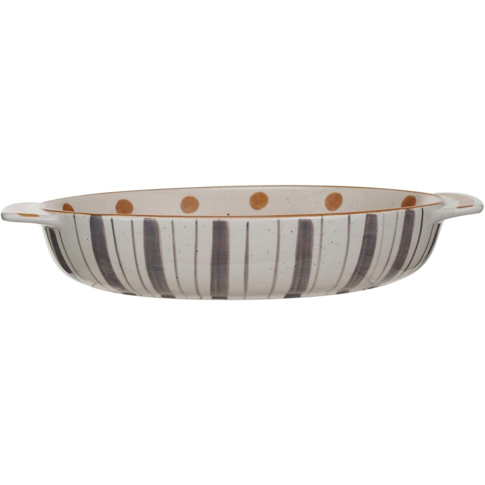 Oval stoneware baking dish with grey vertical stripes on the outside and brown polka dots along the inner rim.
